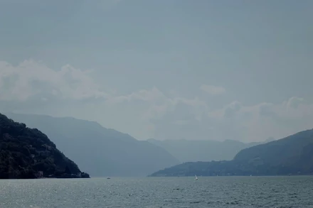 The same photo after one-click enhance: deeper contrast, clearer mountains, richer color