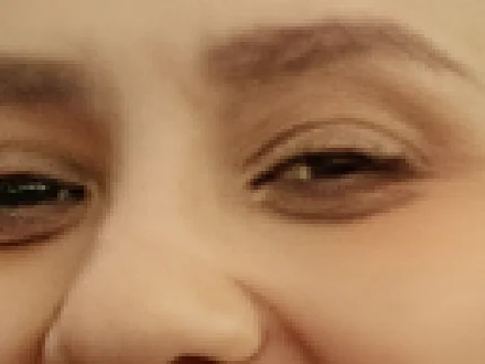 The same eyes after the 2× AI upscale: smooth edges, same features